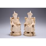 A PAIR OF CHINESE IVORY FIGURES, 19TH CENTURY, carved as a seated emperor and empress, each bears