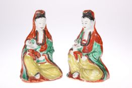 A PAIR OF CHINESE FAMILLE VERTE FIGURES OF GUANYIN, the Bodhisattva modelled seated at each with