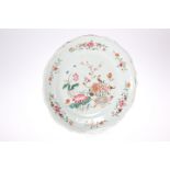 AN 18TH CENTURY CHINESE FAMILLE ROSE DISH, shaped circular form, enamel painted with a vase of