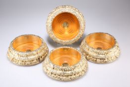 A SET OF FOUR LARGE VICTORIAN SILVER-GILT BOTTLE COASTERS, by John Waterhouse & Edward Hatfield &