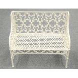 A GOTHIC STYLE WHITE PAINTED METAL GARDEN BENCH decorated with quatrefoil panels to the back. 97.5cm