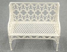 A GOTHIC STYLE WHITE PAINTED METAL GARDEN BENCH decorated with quatrefoil panels to the back. 97.5cm