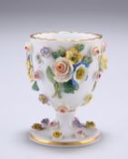 A MEISSEN FLORAL ENCRUSTED EGG CUP, with applied sprigs of foliage and flowerheads, painted with