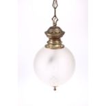 AN EARLY 20TH CENTURY BRASS AND FROSTED GLASS PENDANT CEILING LIGHT, the globular shade with oval