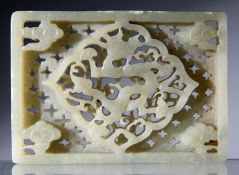 A CHINESE JADE CARVED PLAQUE, rectangular form and deeply carved and pierced with a central