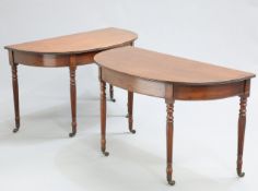 A HANDSOME PAIR OF GEORGE IV MAHOGANY DEMILUNE SIDE TABLES, each with reeded edge and reeded