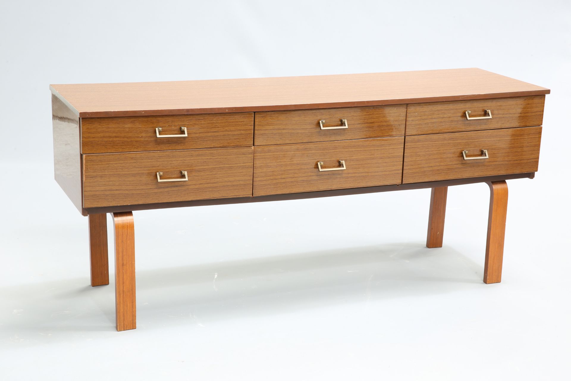 A 1970'S SCHREIBER SIDEBOARD, with six drawers with fixed metal angular handles, raised on U-