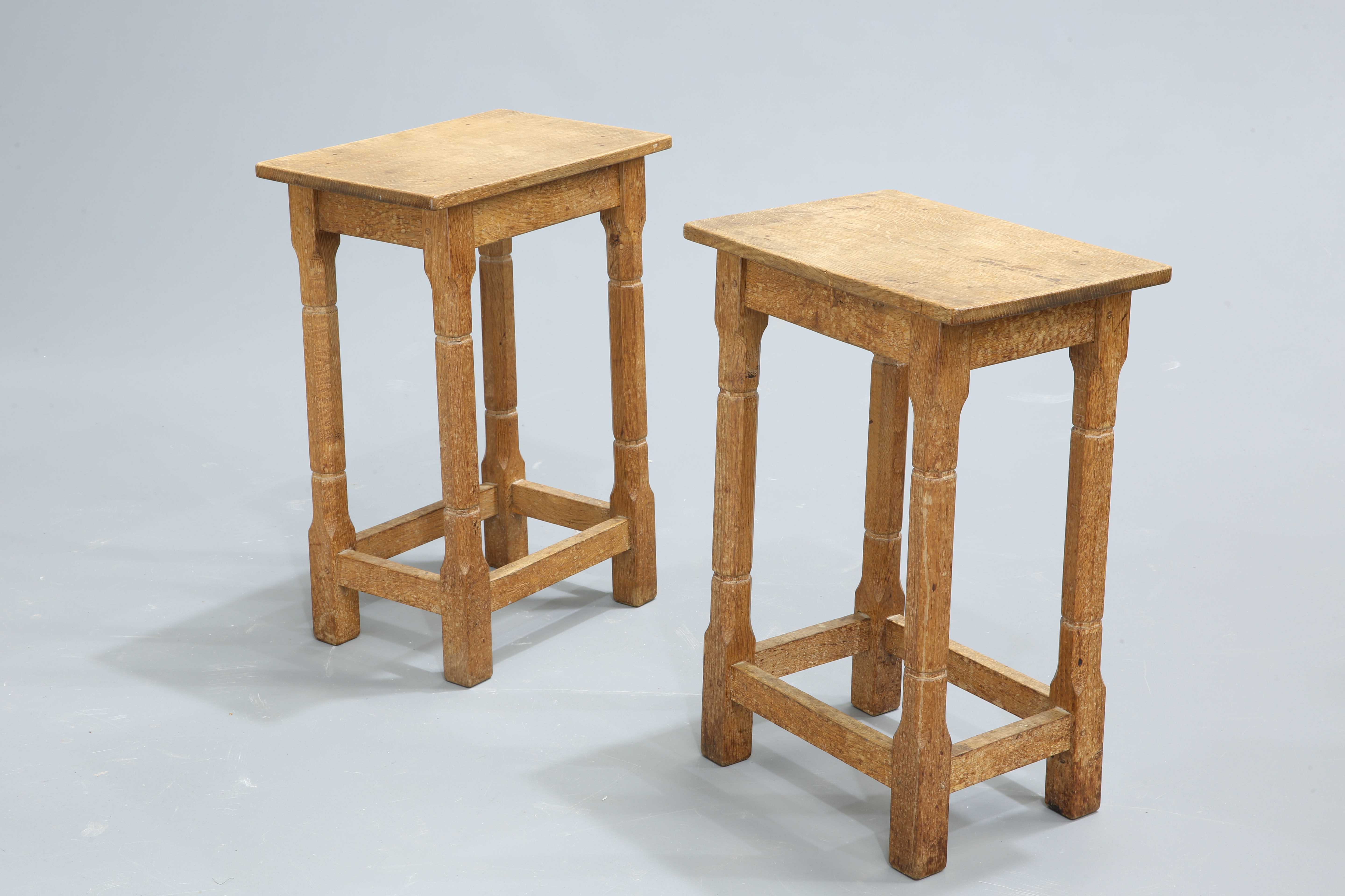 A PAIR OF YORKSHIRE OAK HIGH STOOLS, each with rectangular top raised on octagonal-section legs