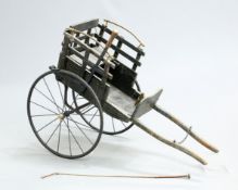 A VICTORIAN SCOTTISH BRASS MOUNTED AND PAINTED DOG CART, fitted with a brake and accompanied by a