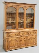 AN OAK DRESSER AND RACK, the glazed upper section with a pair of doors flanking a centre panel,