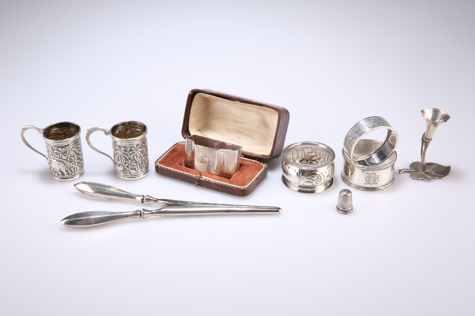 A GROUP OF SILVER AND WHITE METAL, including three napkin rings; a thimble by Saunders & Shepherd;