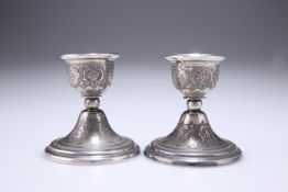 A PAIR OF RUSSIAN SILVER DWARF CANDLESTICKS, EARLY 20TH CENTURY, of squat form with stepped circular