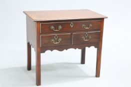 A GEORGE III MAHOGANY LOWBOY, the moulded rectangular top above a long drawer over a pair of short