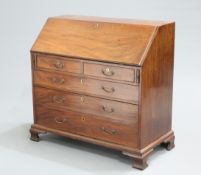 A GEORGE III MAHOGANY SLANT FRONT BUREAU, the moulded rectangular slope opening to reveal a fitted