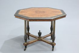 AN AESTHETIC EBONISED AND GILDED BURR YEW CENTRE TABLE, the moulded octagonal top raised on fluted