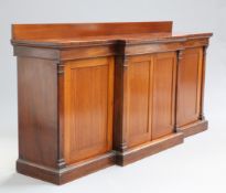 AN EARLY 19TH CENTURY MAHOGANY BREAKFRONT SIDE CABINET, with two pairs of cupboard doors