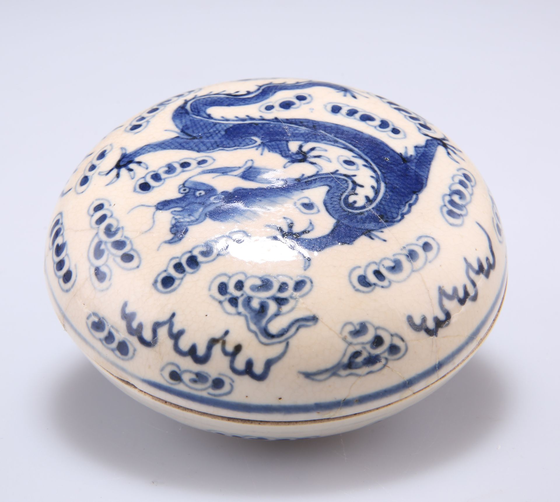 A CHINESE BLUE AND WHITE 'DRAGON' BOX AND COVER, circular, the cover painted with a scaly five-
