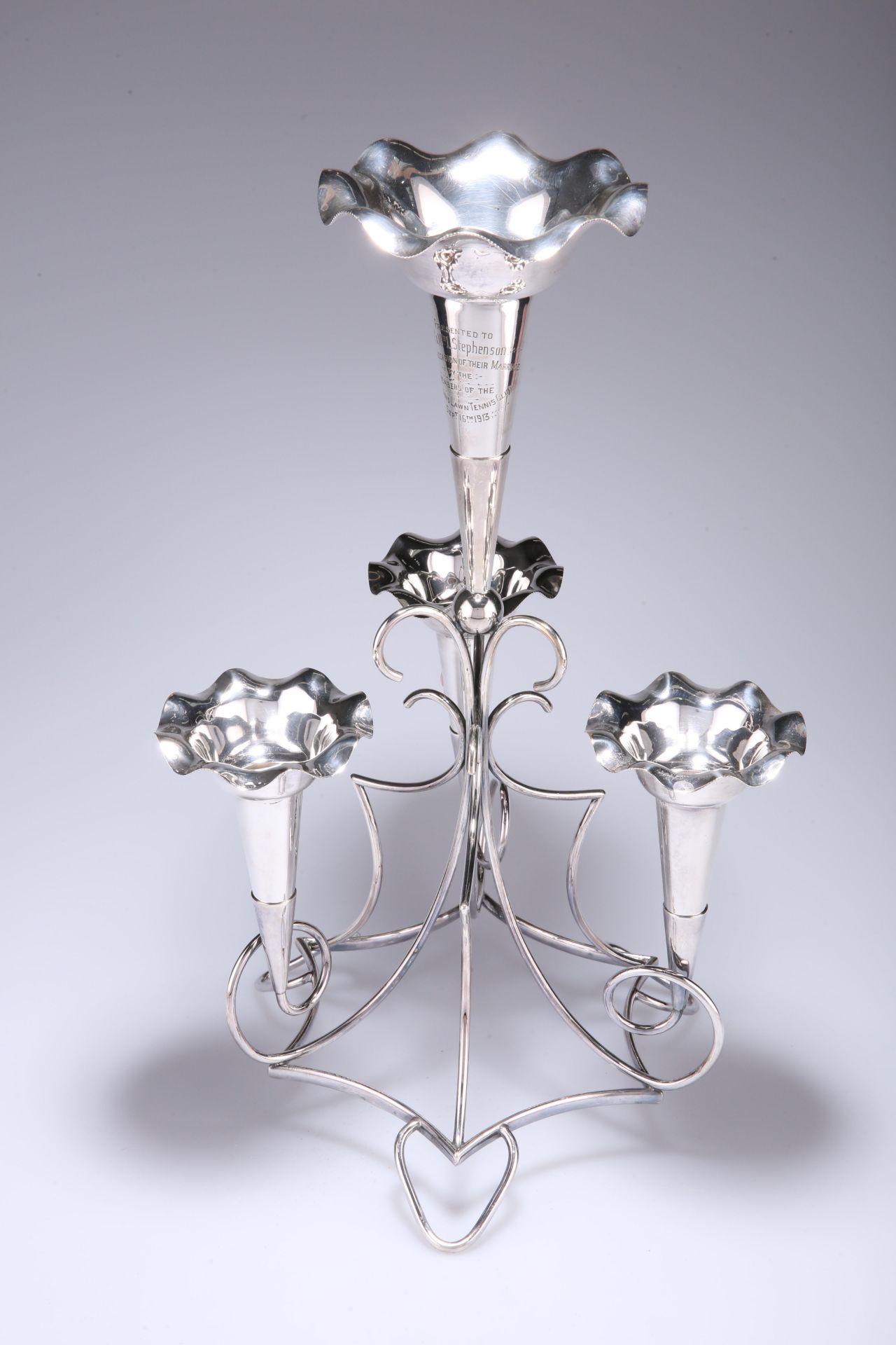 A GEORGE V ELECTROPLATED EPERGNE, LONG CARDIFF, formed of an elaborate scrolling frame with large