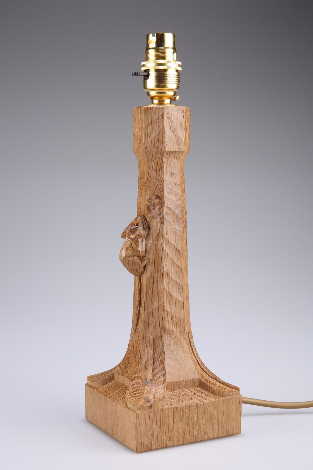 ROBERT THOMPSON OF KILBURN A MOUSEMAN OAK TABLE LAMP with tapering octagonal stem and square base