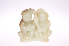 A CHINESE PALE GREEN AND RUSSET JADE 'HE-HE ER XIAN' GROUP, probably 18th Century, the twins with