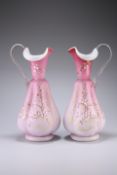 A LARGE PAIR OF VICTORIAN PINK SATIN GLASS EWERS, each of lobed baluster form with clear handle
