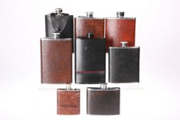 EIGHT VARIOUS HIP FLASKS, all leather covered stainless steel, with screw lids. 14cm high and