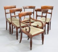 A MATCHED SET OF SIX REGENCY DINING CHAIRS, including a carver, each with reeded legs and drop-in