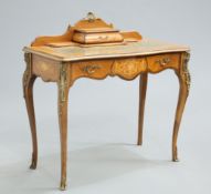 A LOUIS XV STYLE GILT-METAL MOUNTED WALNUT LADY'S WRITING DESK, the rectangular top with shaped