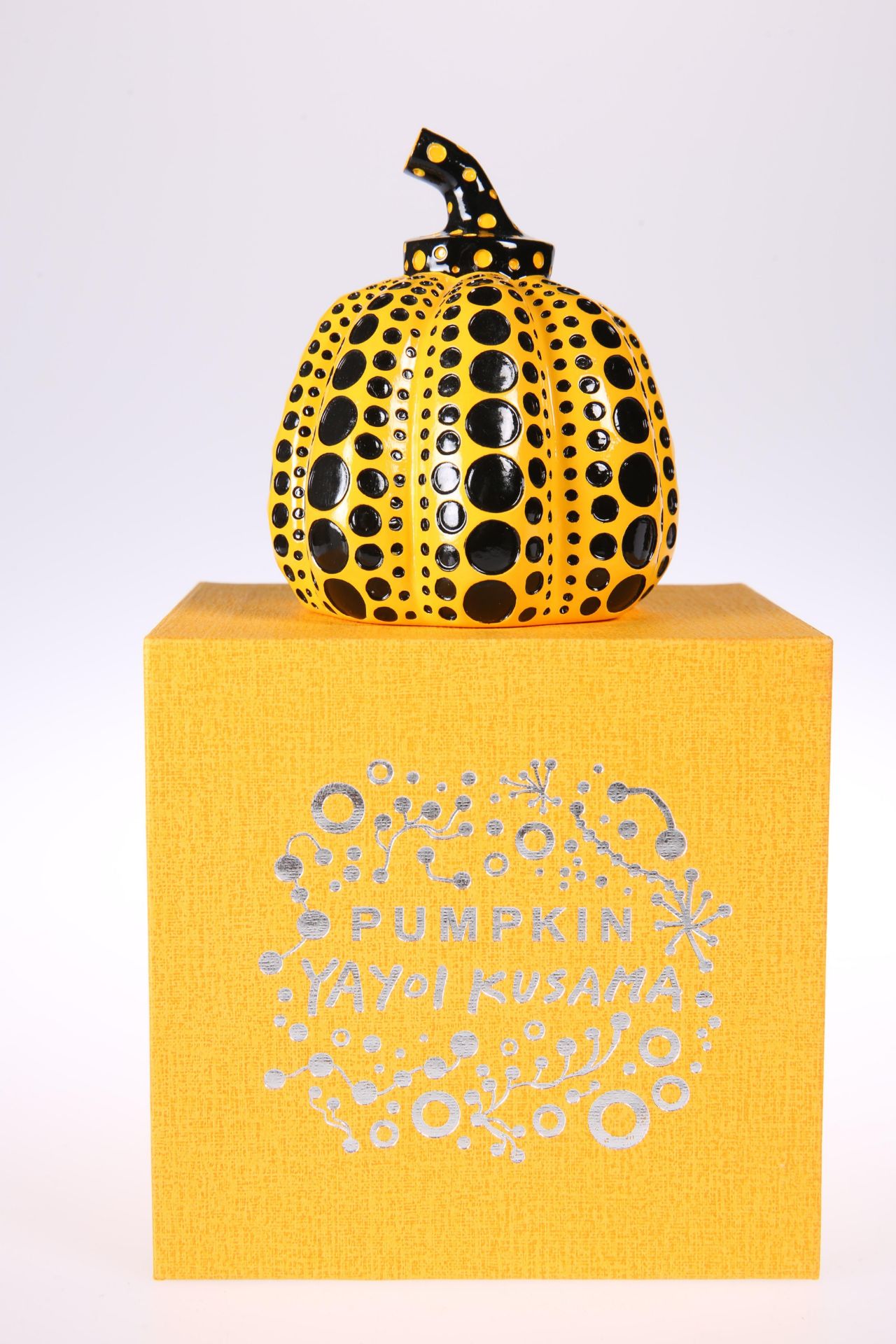 YAYOI KUSAMA (JAPANESE, BORN 1929) 'PUMPKIN' (ORANGE AND BLACK), cast resin, in presentation box.