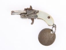 A MINIATURE SINGLE-SHOT PISTOL WITH MOTHER-OF-PEARL GRIP.