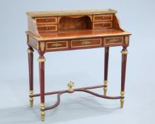 AN EMPIRE STYLE GILT METAL MOUNTED LADY'S WRITING DESK, the superstructure with drawers and pigeon