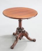 A VICTORIAN MAHOGANY TRIPOD TABLE, the circular top raised on a cylindrical stem with leaf-carved