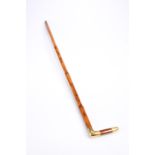 A YELLOW-METAL MOUNTED MALACCA CANE, late 19th Century, engraved with a monogram. 89.5cm