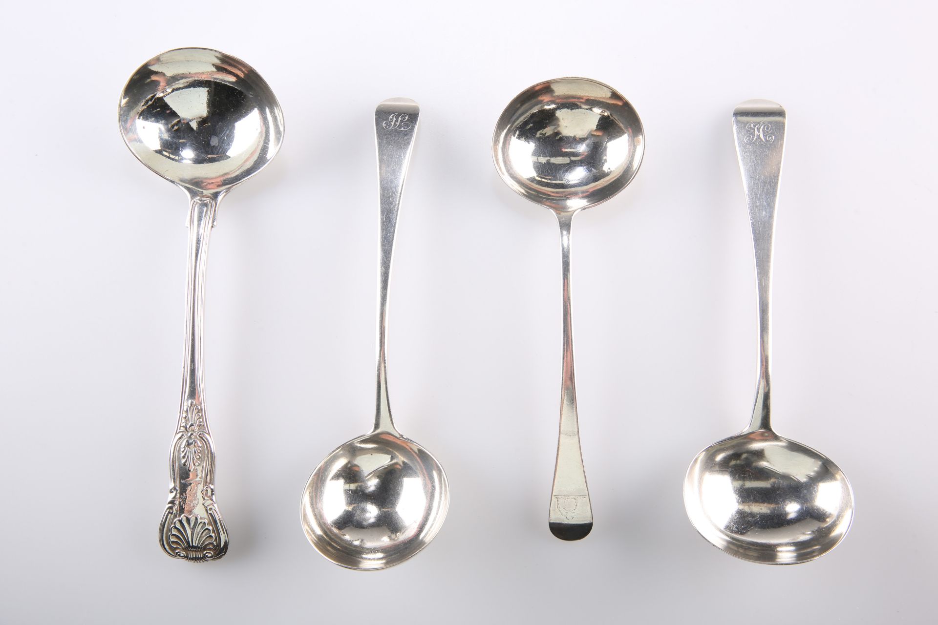 A GROUP OF FOUR GEORGIAN AND VICTORIAN SILVER SAUCE LADLES, comprising a Kings pattern ladle, by