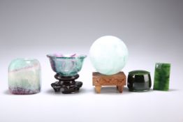 THREE PIECES OF CARVED FLUORITE, COMPRISING A BOWL on a Chinese carved wood stand, 5cm by 9.5cm; A