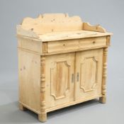 ~ A CONTINENTAL 19TH CENTURY PINE SIDE CABINET, with shaped gallery back and a pair of frieze