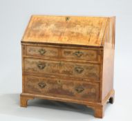 AN EARLY 18TH CENTURY FEATHERBANDED WALNUT SLANT-FRONT BUREAU, with quarter-veneered top and