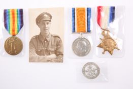 A WWI MEDAL TRIO, SERVICE BADGE AND PHOTOGRAPH, 10075 G. Halford GLOUC. R., badge no. 223346.