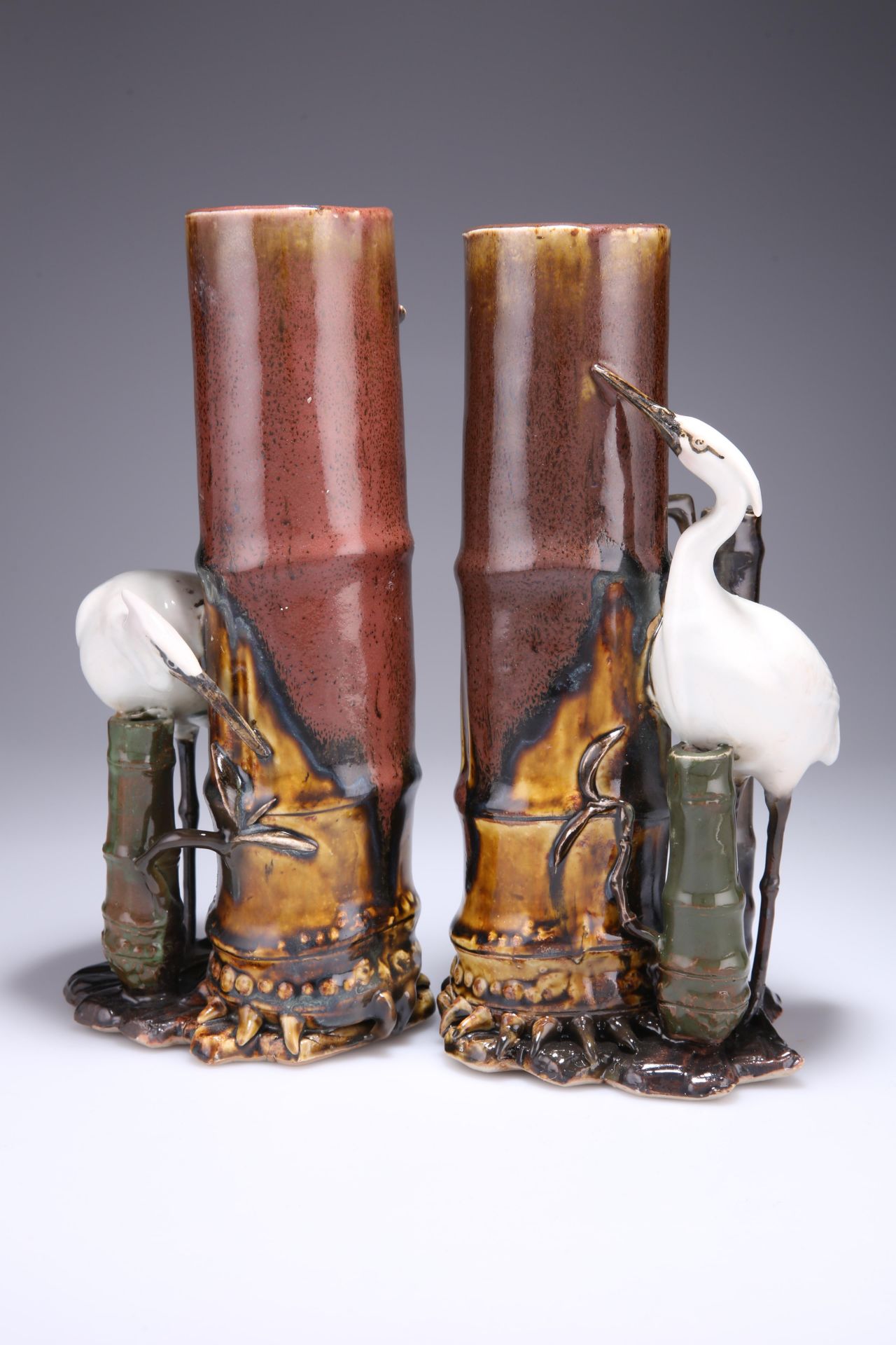 A PAIR OF JAPANESE POTTERY VASES, EARLY 20TH CENTURY, modelled as bamboo with a crane standing