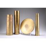 THREE BRASS SHELL CASES AND A SHELL CASE HEAD
