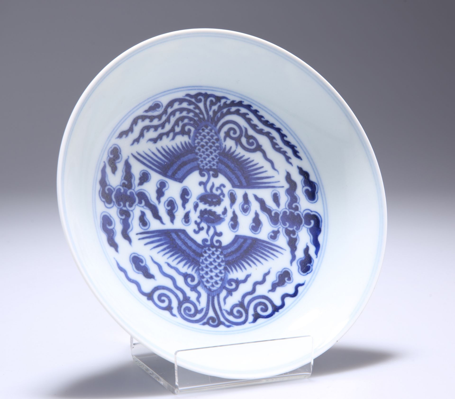 A CHINESE BLUE AND WHITE 'DOUBLE PHOENIX' SAUCER DISH, decorated to the interior with a pair of