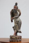 A LARGE CHINESE CARVED, PAINTED AND GILDED FIGURE modelled standing in flowing robes. 89.5cm high