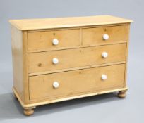 A VICTORIAN PINE CHEST OF DRAWERS, the moulded rectangular top with rounded corners above two