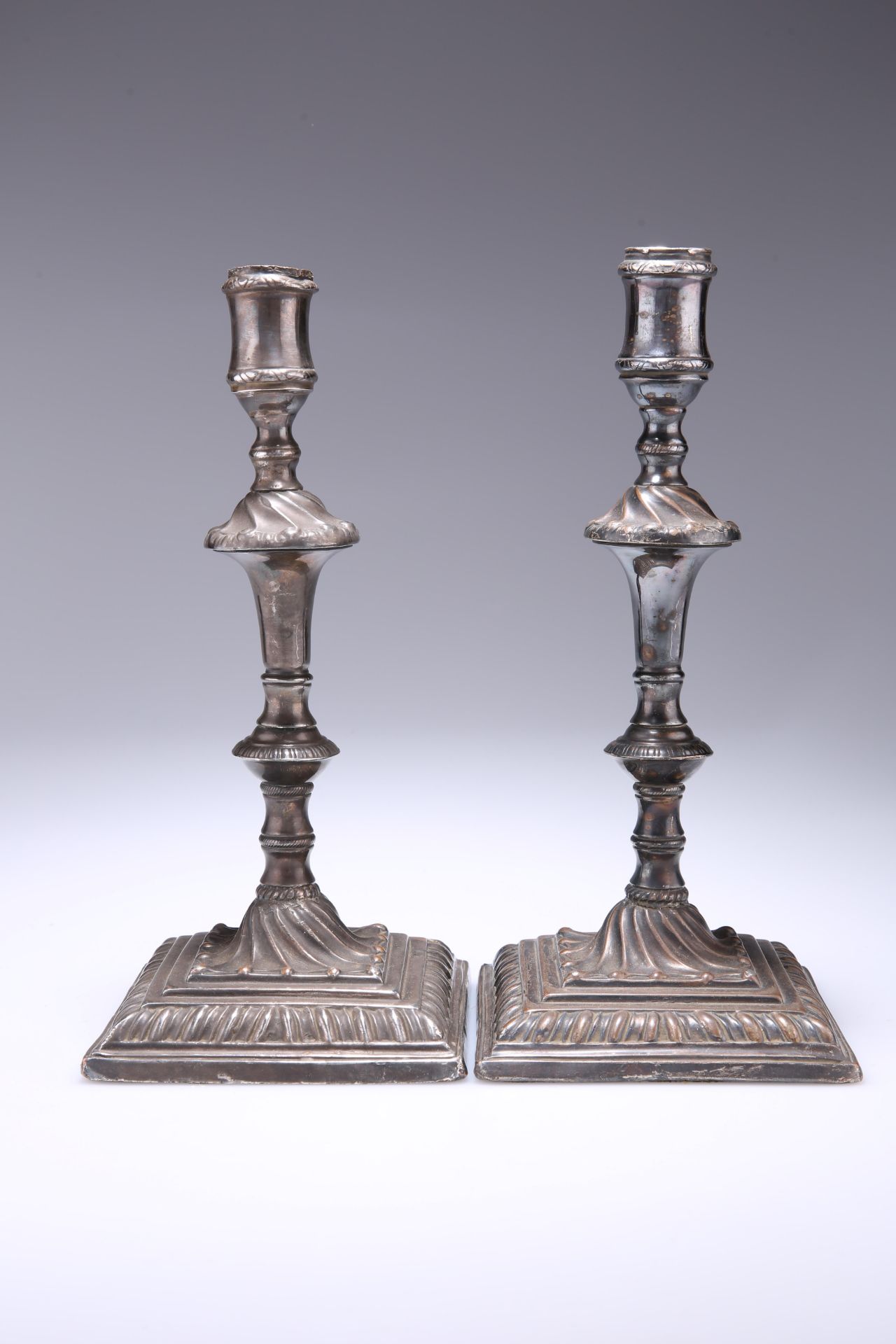 A PAIR OF OLD SHEFFIELD PLATE CANDLESTICKS, tapered knopped stems, with wrythen fluted decoration,