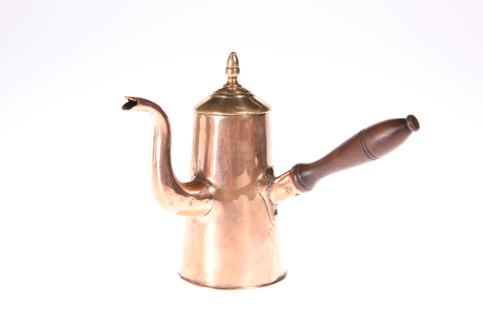 A GEORGIAN COPPER CREAM JUG, in the form of a chocolate pot, with turned wooden handle. 10.4cm