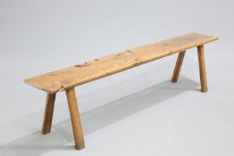A 19TH CENTURY ELM BENCH, with splayed chamfered legs. 183cm longThe absence of a Condition Report