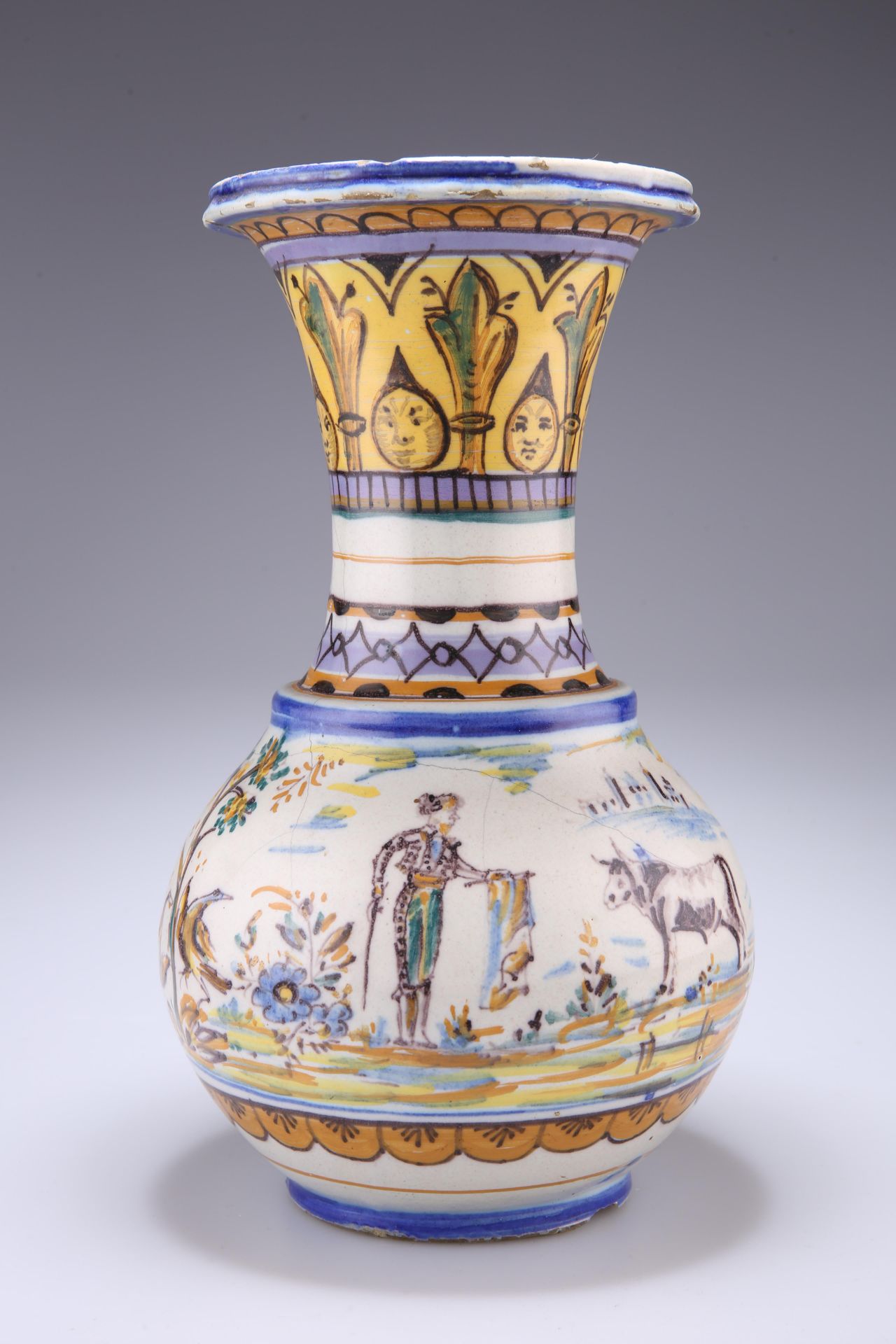 A SPANISH FAIENCE VASE, the globular body with large trumpet neck, painted with a bull fighting