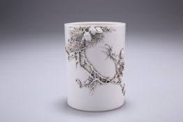 A CHINESE BLANC DE CHINE BRUSH POT, cylindrical, decorated in relief with an insect amidst