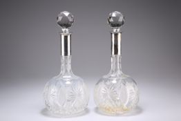 A PAIR OF GERMAN SILVER METAL MOUNTED CUT GLASS DECANTERS, by Wilhelm Binder, globular form with ray