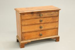 A MID-19TH CENTURY PINE MINIATURE CHEST OF DRAWERS, with four graduated drawers with brass pulls,